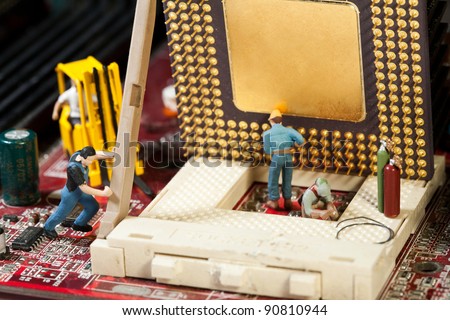 Miniature Maintenance Team. A team of miniature toy figurines busy with repair and maintenance.