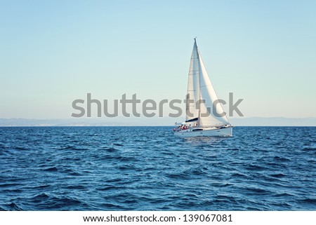 Racing yacht in the Mediterranean Sea on blue sky background