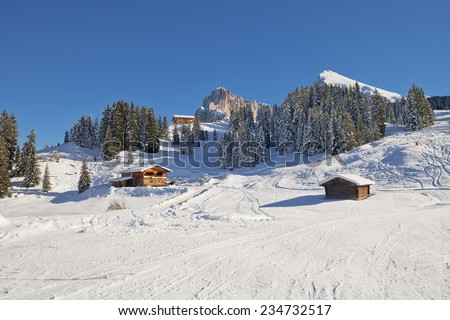 Typical wooden chalet in the Dolomites mountain in winter, South Tyrol, Italy