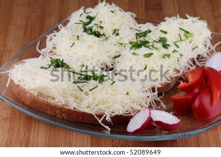 Bread with butter and cheese on plate.