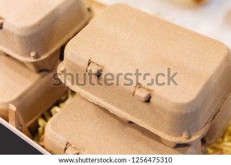 Brown chicken eggs in a brown carton box.