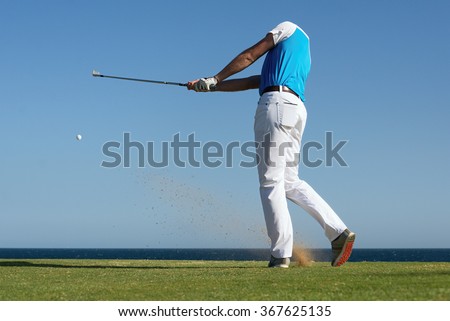 Golfer hitting ball with force. The grass distribution The blur of golf