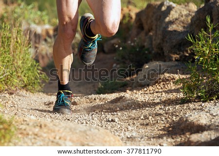 trail running man on mountain path exercising