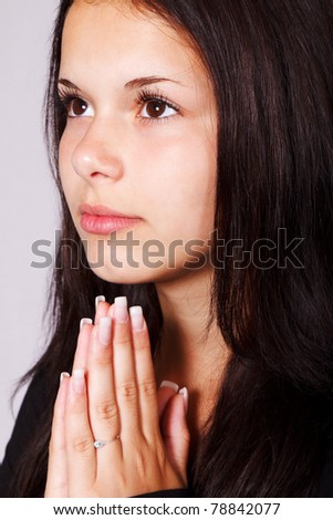 young woman is praying to god