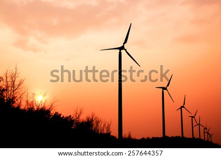 the wind turbine with the sunset