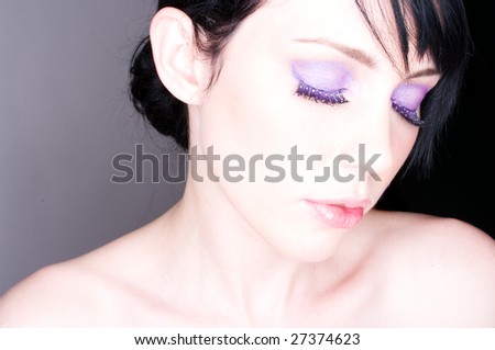 Pretty face shot of model with purple eye makeup