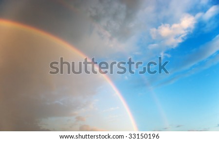 Optical phenomenon - effect of a double rainbow in beautiful cloudy sky