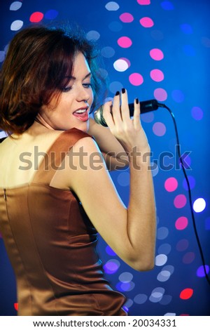 Beautiful female singing on stage