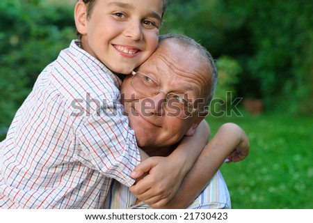 Happy grandfather and grandson outdoors