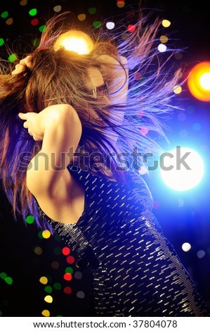Young woman dancing in the nightclub