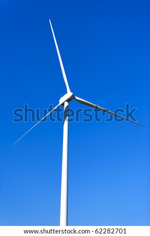 wind turbine propeller blades against blue sky, space for copy