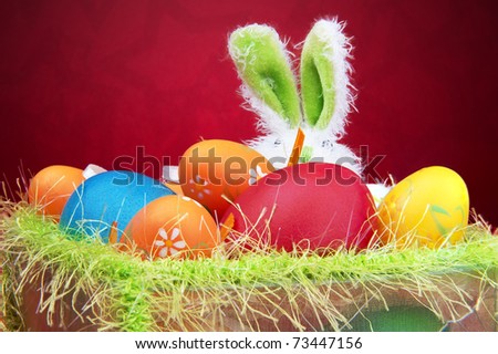 easter eggs in a basket with a bunny. stock photo : Easter eggs in a