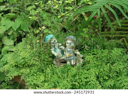 A girl and a boy dolls,sitting on the green grass meadow (love concept)