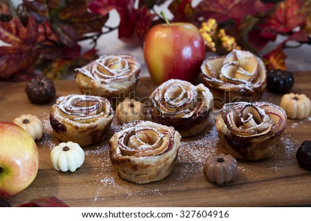 Baked Rose Apples made for a Thanksgiving holiday dessert surrounded by pumpkin chocolates