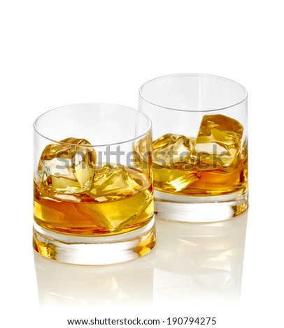 close up of  a whiskey with ice cubes on white background