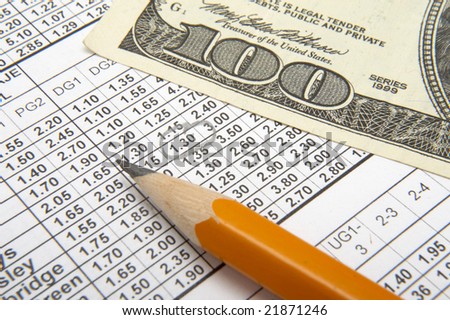 stock-photo-close-up-of-sports-betting-slip-pencil-and-one-hundred-dollars-21871246.jpg