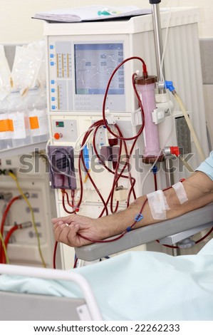 patient monitored by electronic sphygmomanometer during dialysis session
