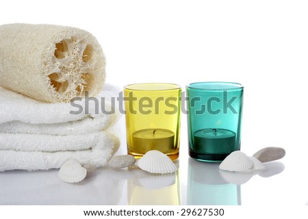 well being concept with towel, candle and plants on white background