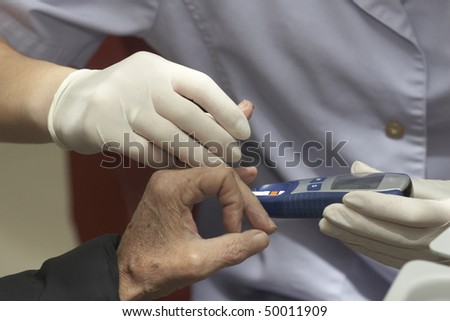 close up of blood extraction and diabetes monitoring in lab