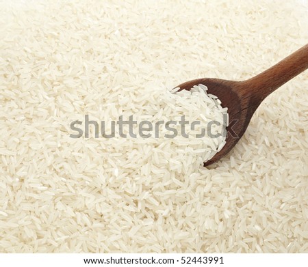 close up of white rice cereal and wooden spoon