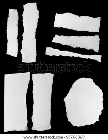 collection of  white ripped pieces of paper on black