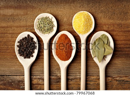 collection of various food ingredients in wooden spoons