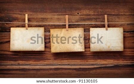close up of an old photo and clothes peg on a wooden background