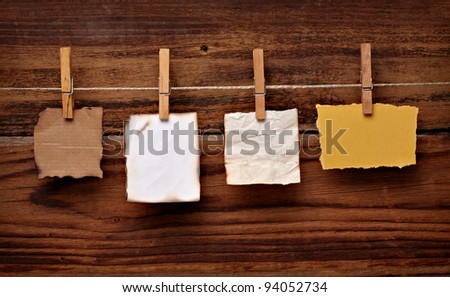 close up of  a note paper and clothes peg on a wooden background