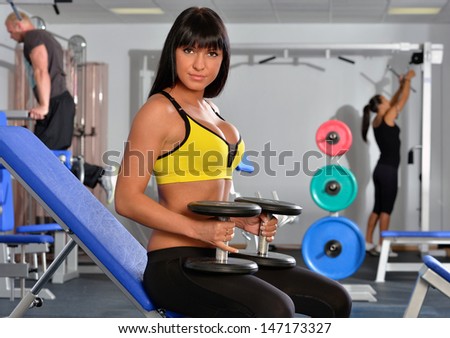 Beautiful woman doing exercises in a sport club.