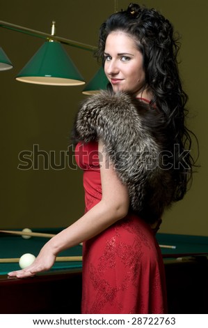 Portrait of the beautiful woman in the billiards club