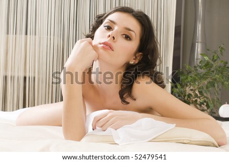 Portrait of the beautiful woman on the  bed