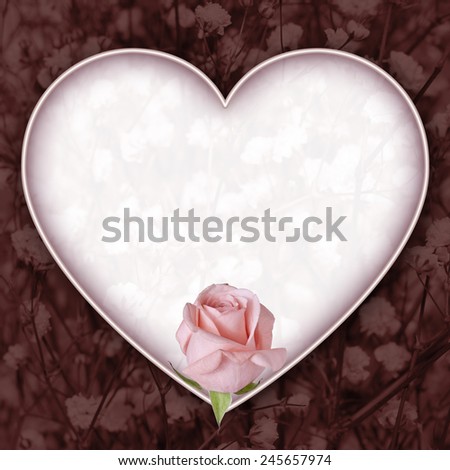 Pink Rose and Dark Red Colorized Baby\'s Breath Heart with Copy Space. A pink rose anchors a heart shaped copy space with deep red background of colorized baby\'s breath.