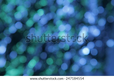 Blue & Green bokeh pattern background. Out of focus points of light form a background of multiple shades of blue, green and white.