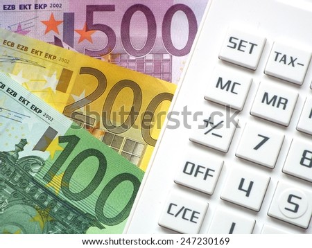 Financial transactions Euro bills lying next to a calculator