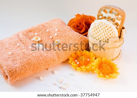 beauty items with aromatherapy candles, towel, flowers