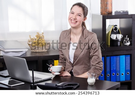Elegant business woman drinking coffee in the office