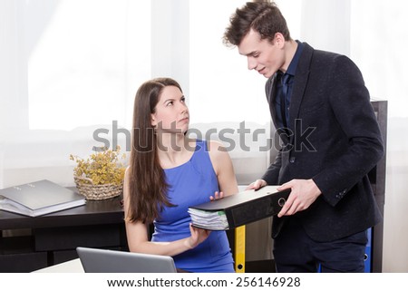 Business man give the documents to his colleague but she does not want to accept