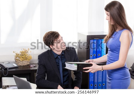 Business woman give the documents to his colleague