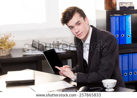 Business man show the tablet in the office