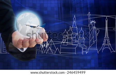 Young businessman holding airplane and digital earth, background famous landmarks