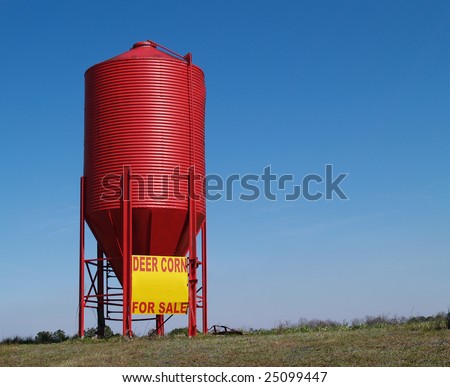 Small red grain silo used to sell corn for deer.