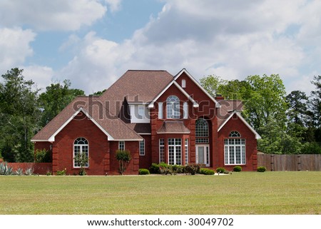 Two story residential home with brick facade.