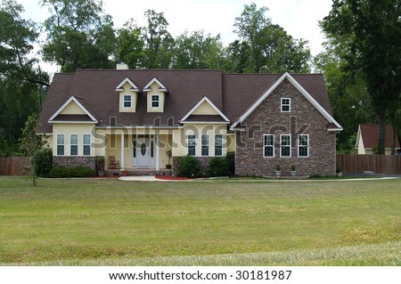 One story residential home with both brick and board siding on the facade.