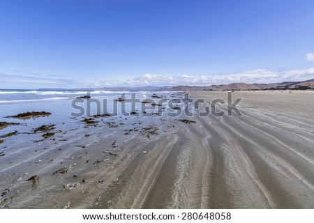Morro Strand State Beach, waves, sand, blue sky and sea, on the California Central Coast, near Cambria CA