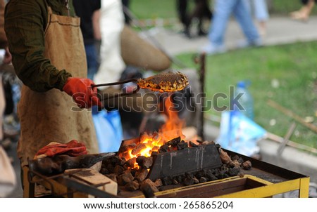 man roasts sunflower on an open fire
