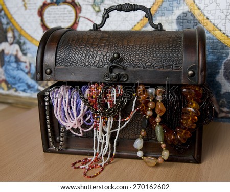 Pirate treasure chest against the background of old maps