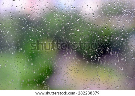 raindrops on glass and urban background