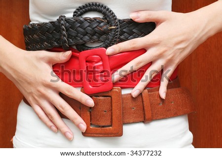 Tight belts around the waist (can be used for fashion, health or budget/finance control concepts)