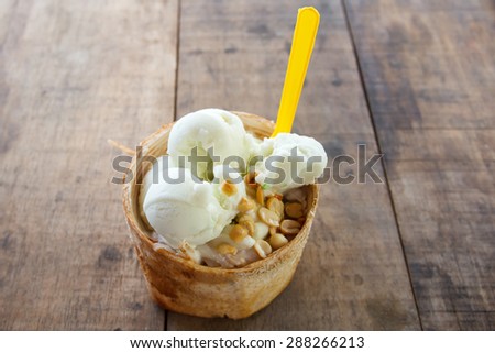 coconut Ice Cream with nuts On a wooden table