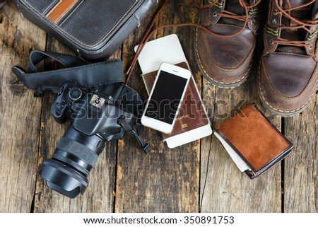 travel concept, Preparation for travel,smartphone, money, passport,camera on wooden table